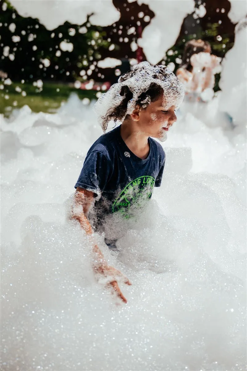 Kids diving into a mountain of foam