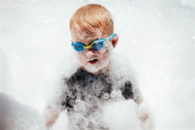 Kids splashing through foam in the backyard