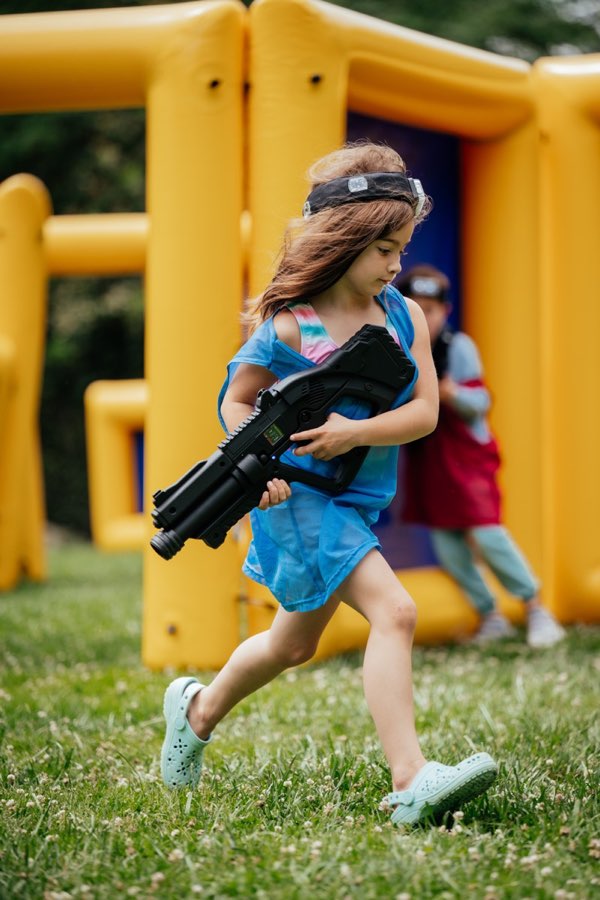 Kid running with laser tag gun